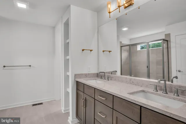 a bathroom with a double vanity sink mirror and double