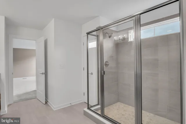 a bathroom with a glass shower door