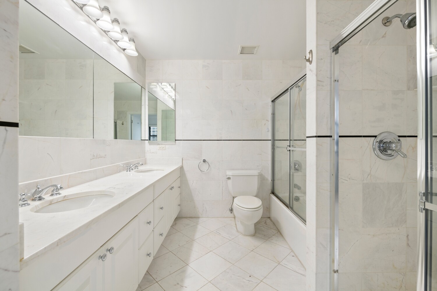 25 Murray Street, Unit 9B Manhattan, NY 10007 - Photo 6 of 15 a bathroom with a sink a toilet and a mirror