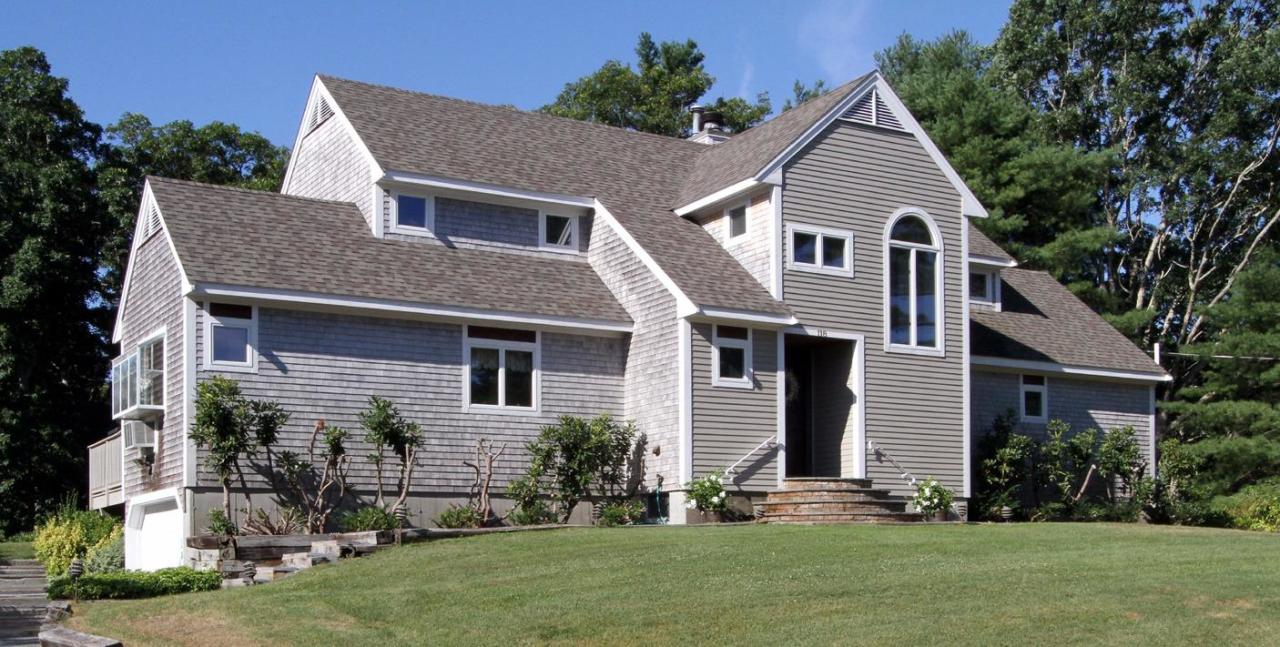 118 Elgin Road Pocasset, MA 02559 - Photo 1 of 35 a front view of a house with a yard and trees