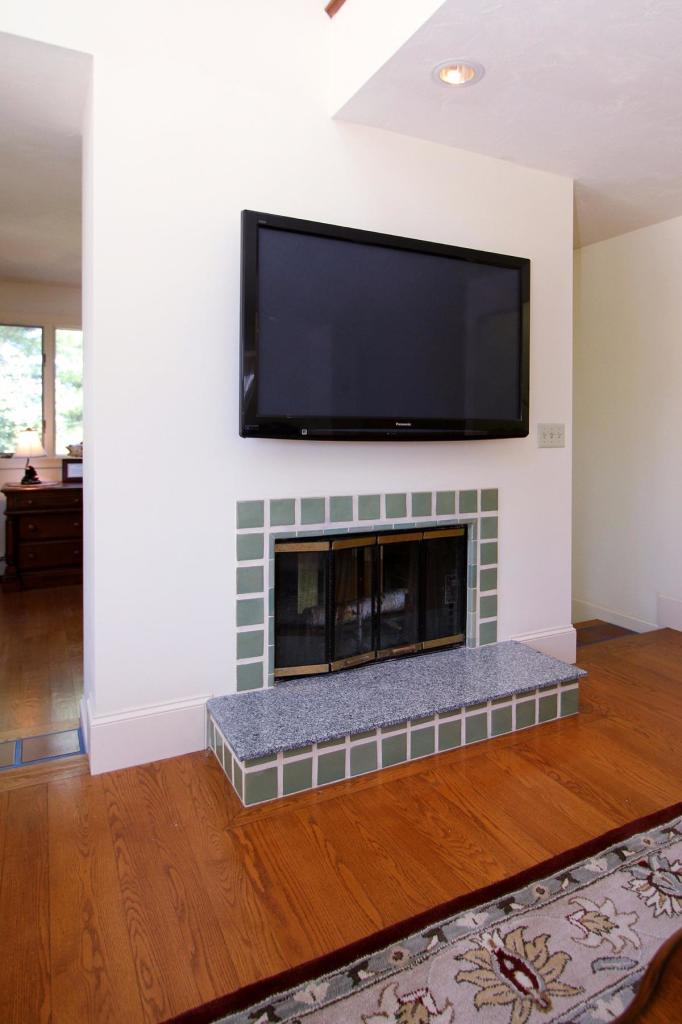 118 Elgin Road Pocasset, MA 02559 - Photo 13 of 35 a living room with a flat screen tv and a fireplace