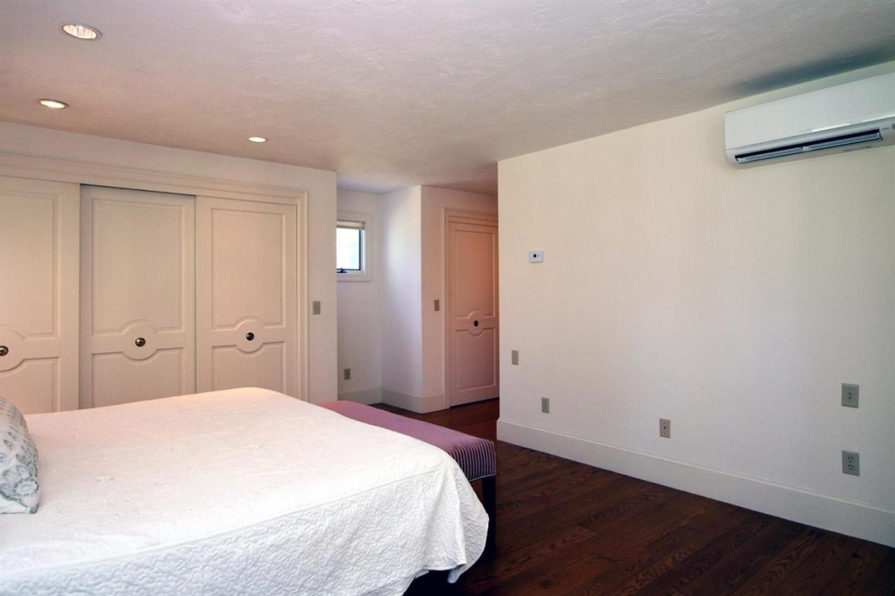 118 Elgin Road Pocasset, MA 02559 - Photo 17 of 35 a bedroom with a bed and wooden floor