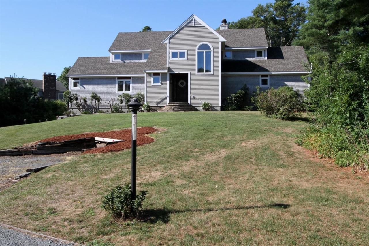 118 Elgin Road Pocasset, MA 02559 - Photo 2 of 35 a view of a white house next to a yard with big yard