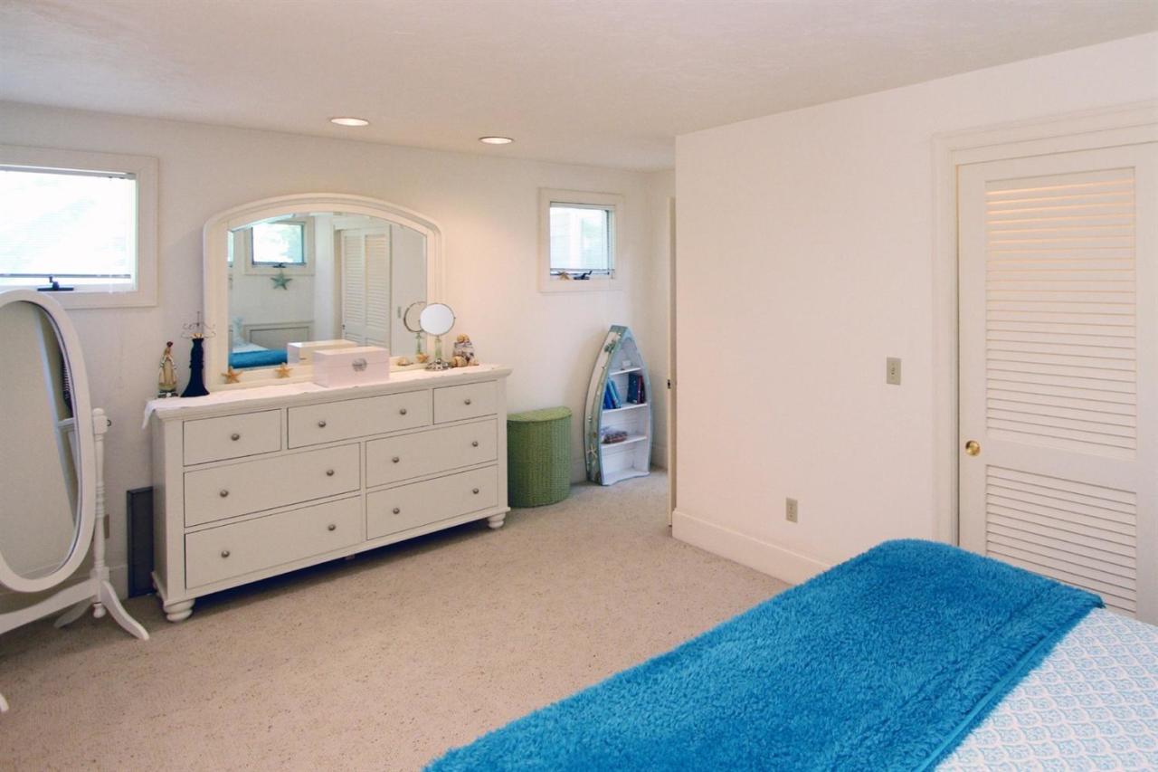 118 Elgin Road Pocasset, MA 02559 - Photo 25 of 35 a view of a bedroom with a bed and a dresser