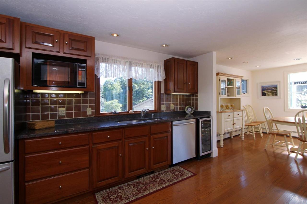 118 Elgin Road Pocasset, MA 02559 - Photo 5 of 35 a kitchen with stainless steel appliances granite countertop a stove a sink and a microwave