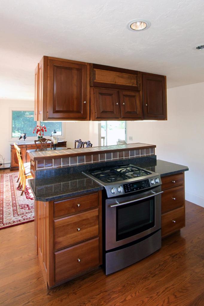 118 Elgin Road Pocasset, MA 02559 - Photo 6 of 35 a kitchen with stainless steel appliances wooden cabinets and a stove top oven