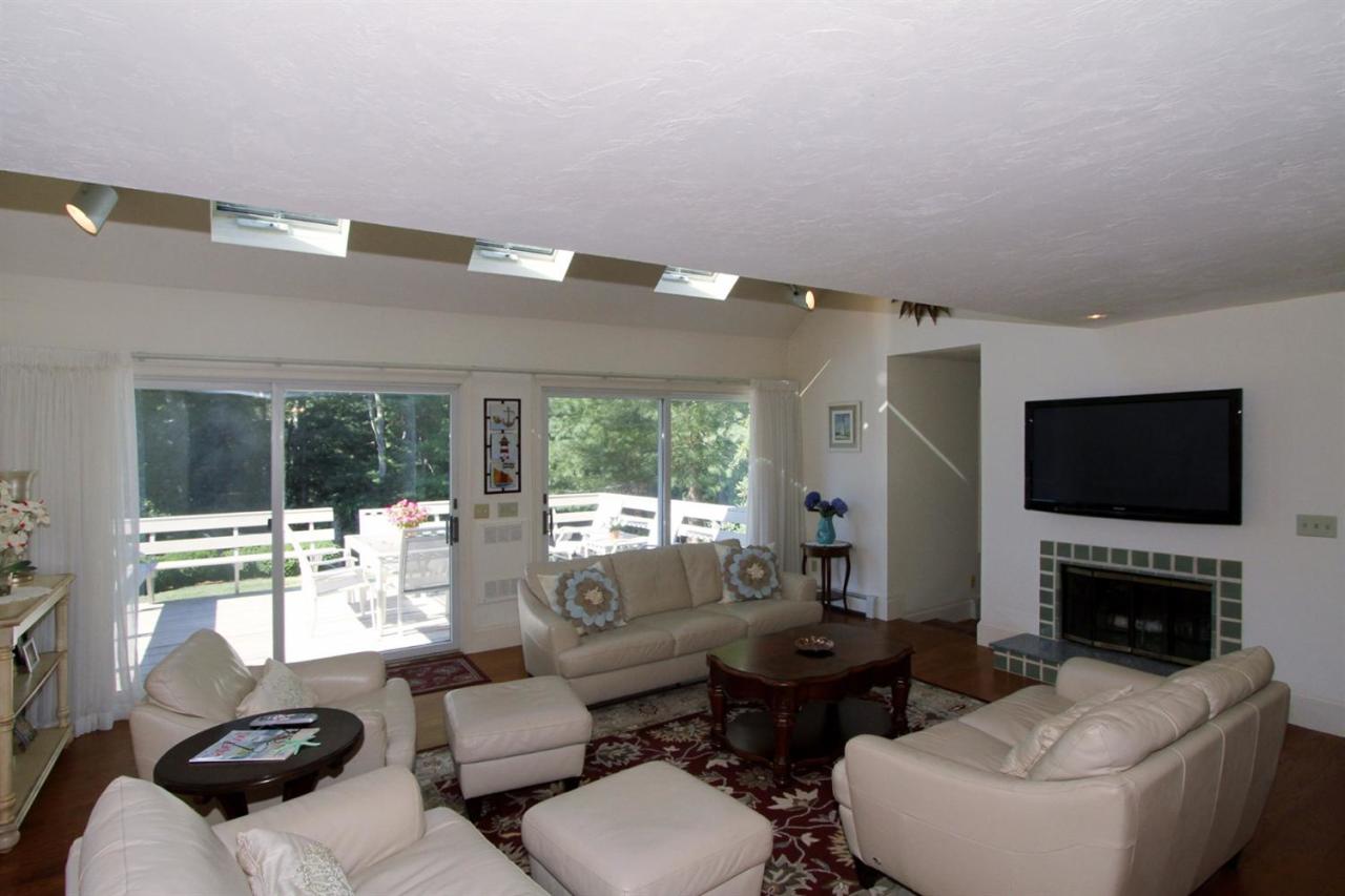 118 Elgin Road Pocasset, MA 02559 - Photo 10 of 35 a living room with furniture a large window and a flat screen tv