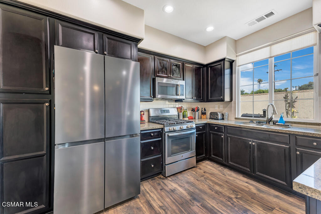 443 Stratus Lane, Unit 3 Simi Valley, CA 93065 - Photo 17 of 41 a kitchen with stainless steel appliances granite countertop a refrigerator stove and sink