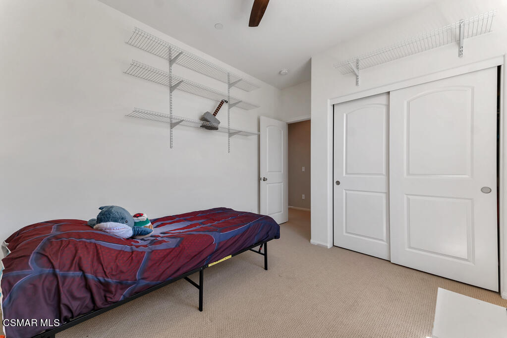 443 Stratus Lane, Unit 3 Simi Valley, CA 93065 - Photo 24 of 41 a bedroom with a bed and painted walls