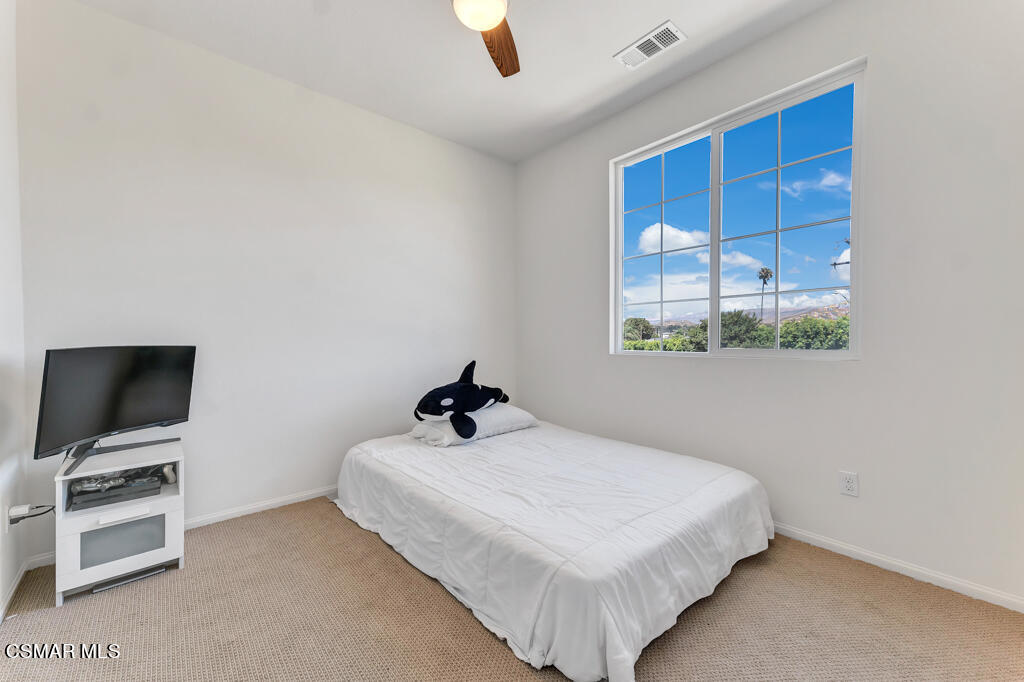 443 Stratus Lane, Unit 3 Simi Valley, CA 93065 - Photo 27 of 41 a bedroom with a bed and a flat screen tv