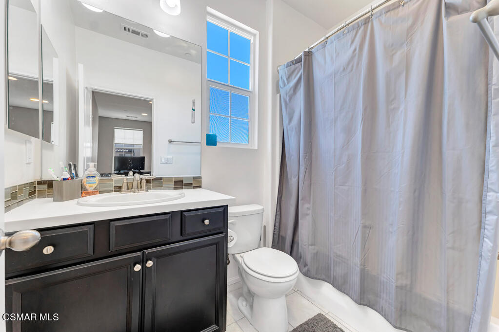 443 Stratus Lane, Unit 3 Simi Valley, CA 93065 - Photo 29 of 41 a bathroom with a sink a toilet and a mirror
