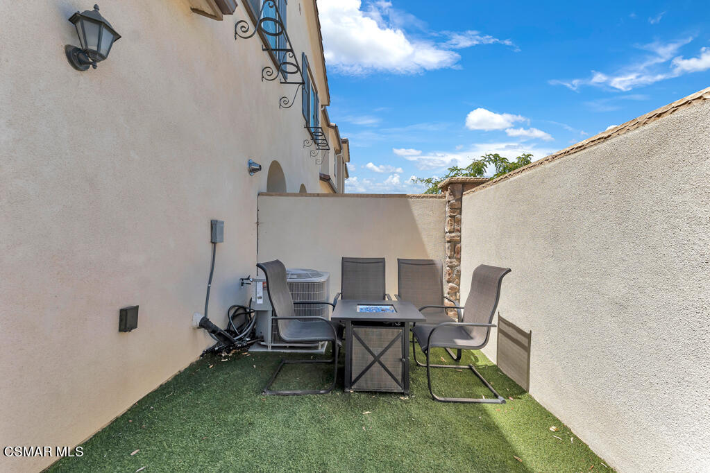 443 Stratus Lane, Unit 3 Simi Valley, CA 93065 - Photo 31 of 41 a patio with table and chairs