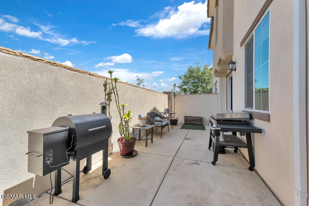 443 Stratus Lane, Unit 3 Simi Valley, CA 93065 - Photo 32 of 41 a view of a patio with table and chairs and potted plants