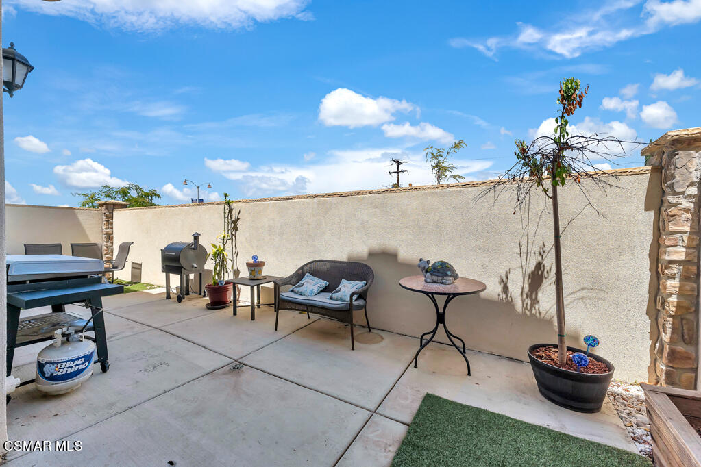 443 Stratus Lane, Unit 3 Simi Valley, CA 93065 - Photo 34 of 41 a view of a patio with table and chairs potted plants