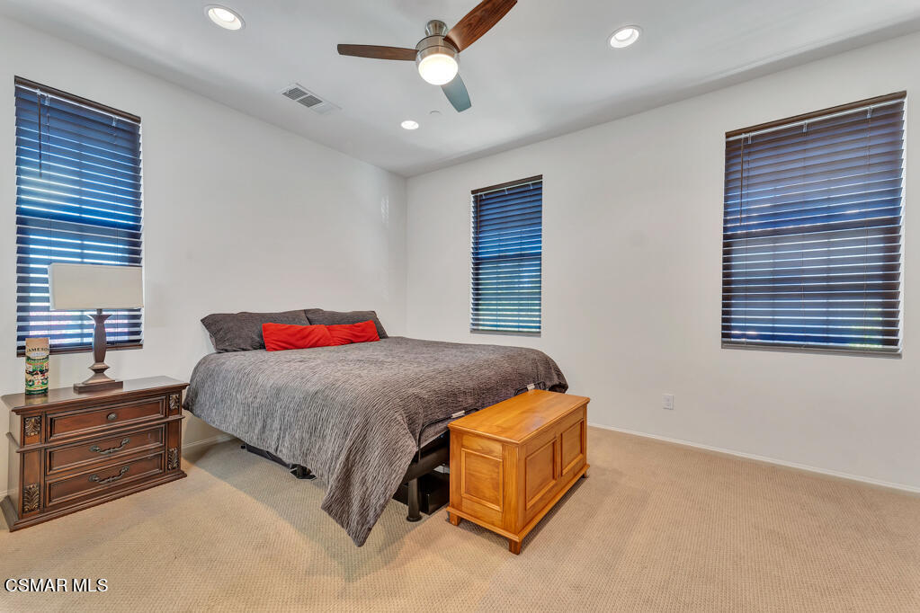 443 Stratus Lane, Unit 3 Simi Valley, CA 93065 - Photo 35 of 41 a bedroom with a bed and a chandelier