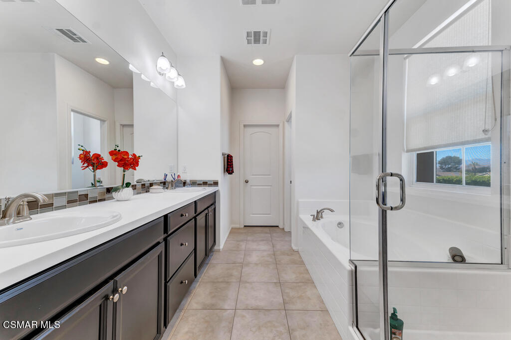443 Stratus Lane, Unit 3 Simi Valley, CA 93065 - Photo 37 of 41 a spacious bathroom with a double vanity sink a mirror and a shower