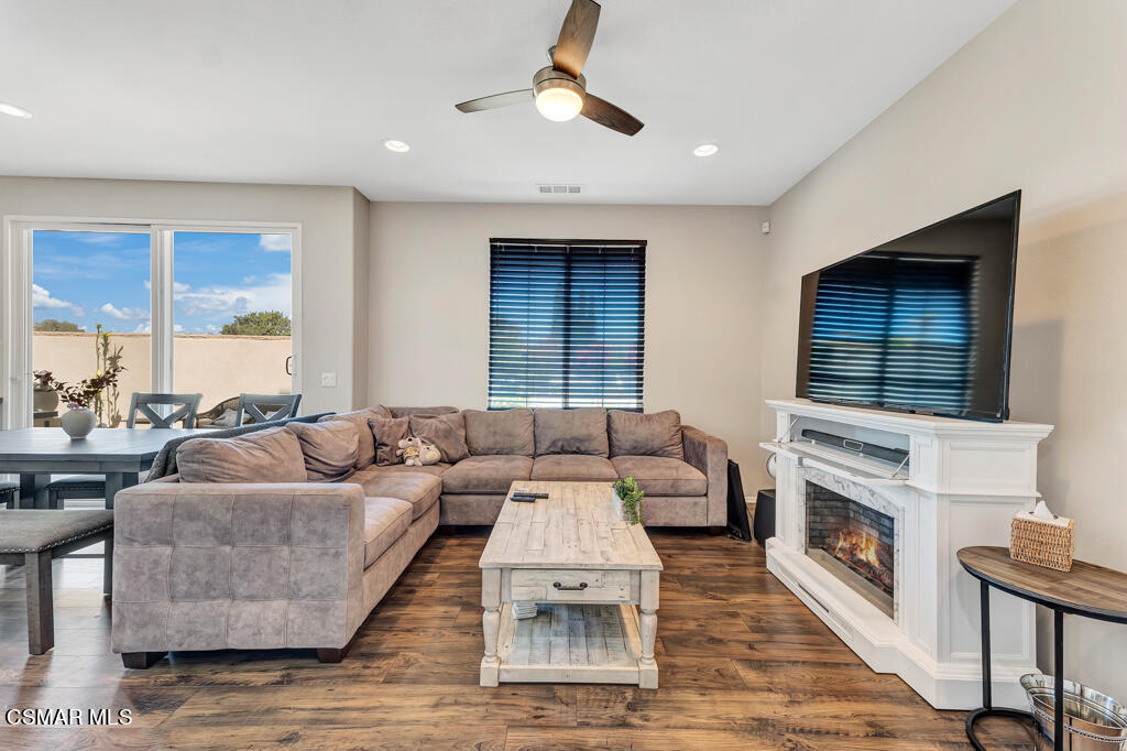 443 Stratus Lane, Unit 3 Simi Valley, CA 93065 - Photo 6 of 41 a living room with furniture a flat screen tv and a fireplace