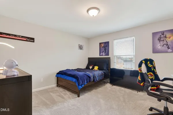 a bedroom with bed and a window