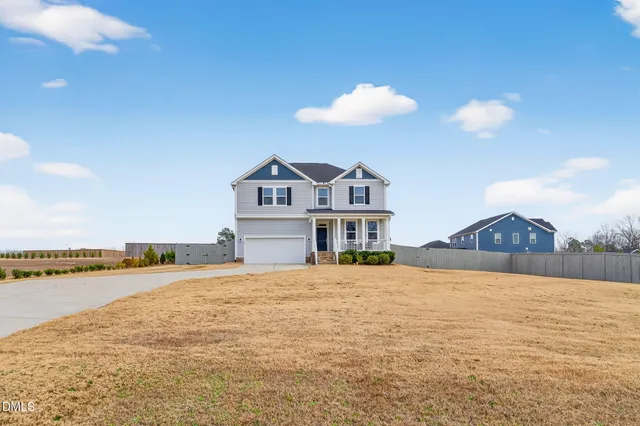 a view of a house with a yard and ocean view