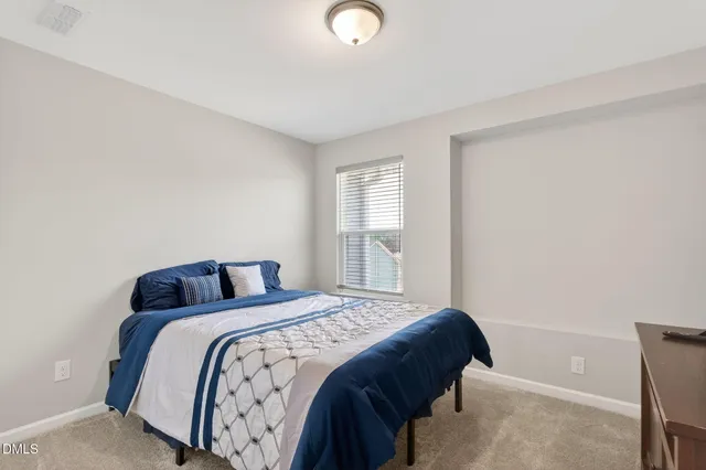 a bedroom with a bed and window