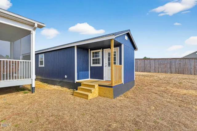 a view of backyard with deck and backyard