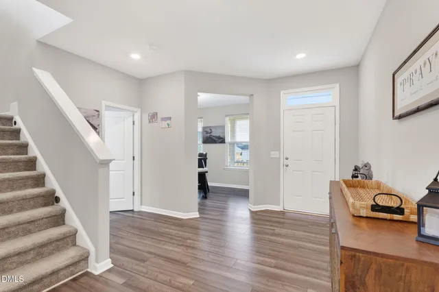 a view of a livingroom with wooden floor and furniture