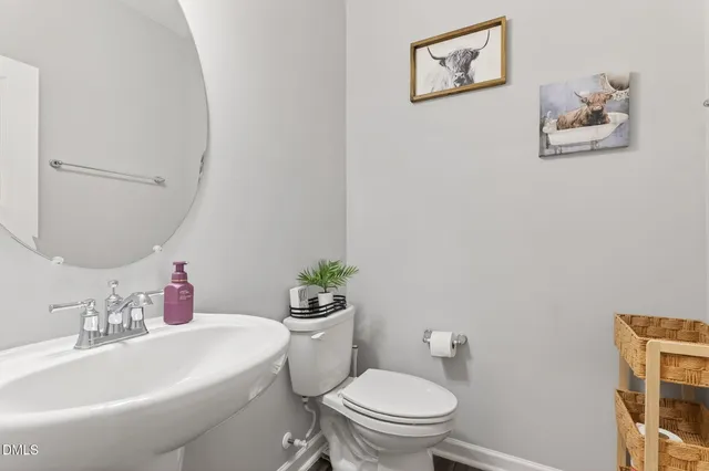 a white toilet sitting next to a bathroom sink