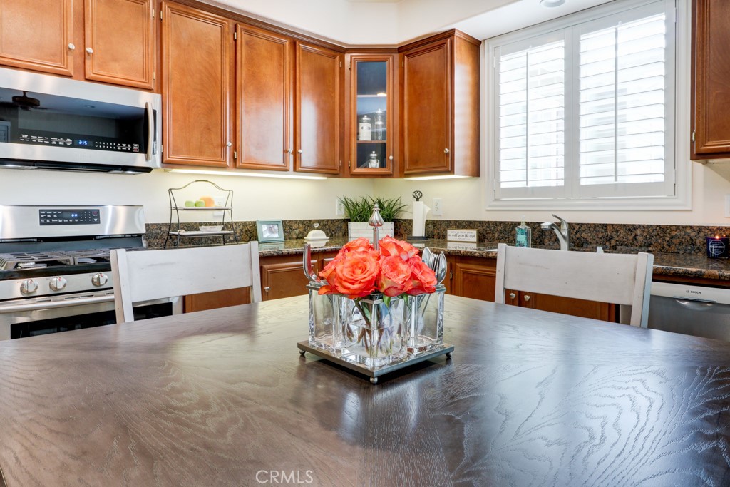 1 Agave Court Ladera Ranch, CA 92694 - Photo 11 of 23 a kitchen with kitchen island granite countertop a stove and a wooden floor