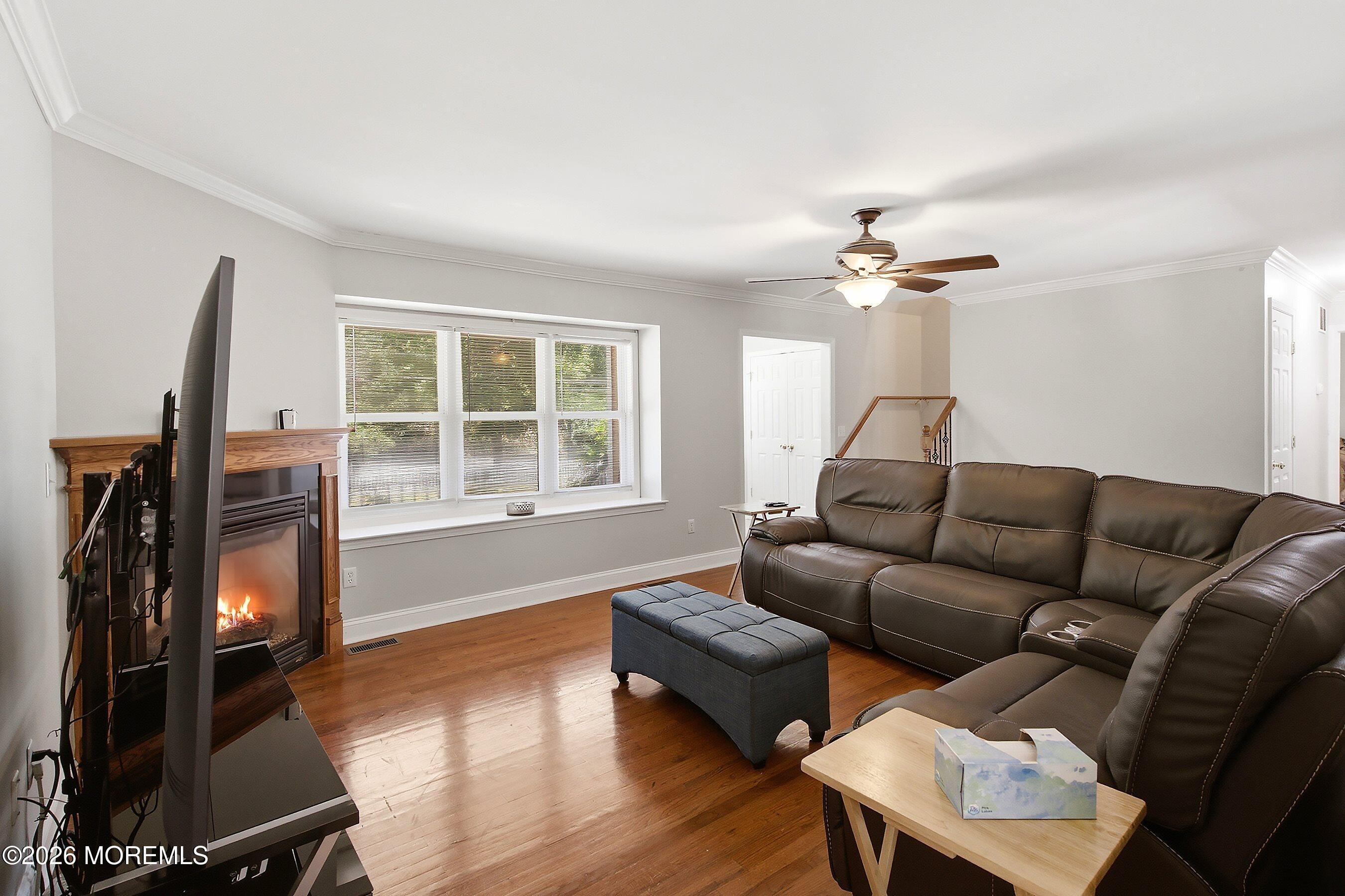 935 Bethel Church Road Jackson, NJ 08527 - Photo 7 of 32 a living room with furniture a flat screen tv and a window