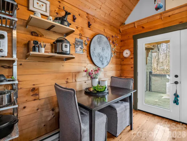 a dining room with furniture and wooden floor