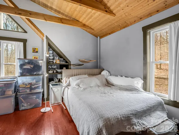 a bedroom with a bed and a view of bedroom