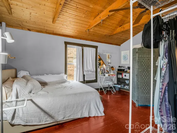 a bed room with a bed and a chair