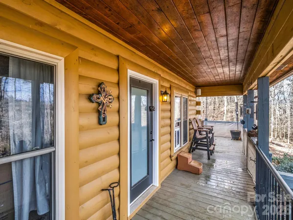 a view of a porch with a table and chairs