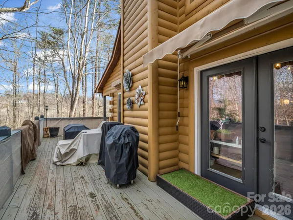 a view of a porch with furniture and a yard