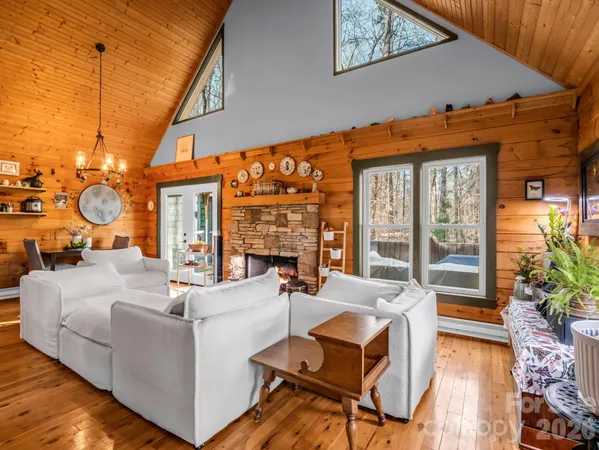 a living room with fireplace furniture and a large window