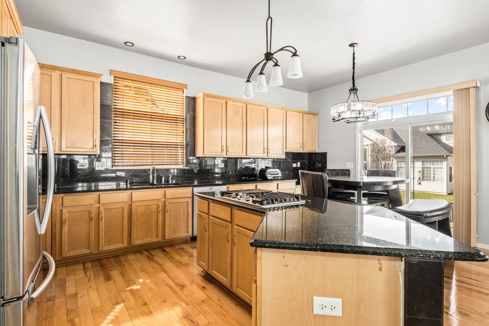 2 Alexander Court Bolingbrook, IL 60490 - Photo 8 of 43 a kitchen with stainless steel appliances granite countertop sink stove and refrigerator