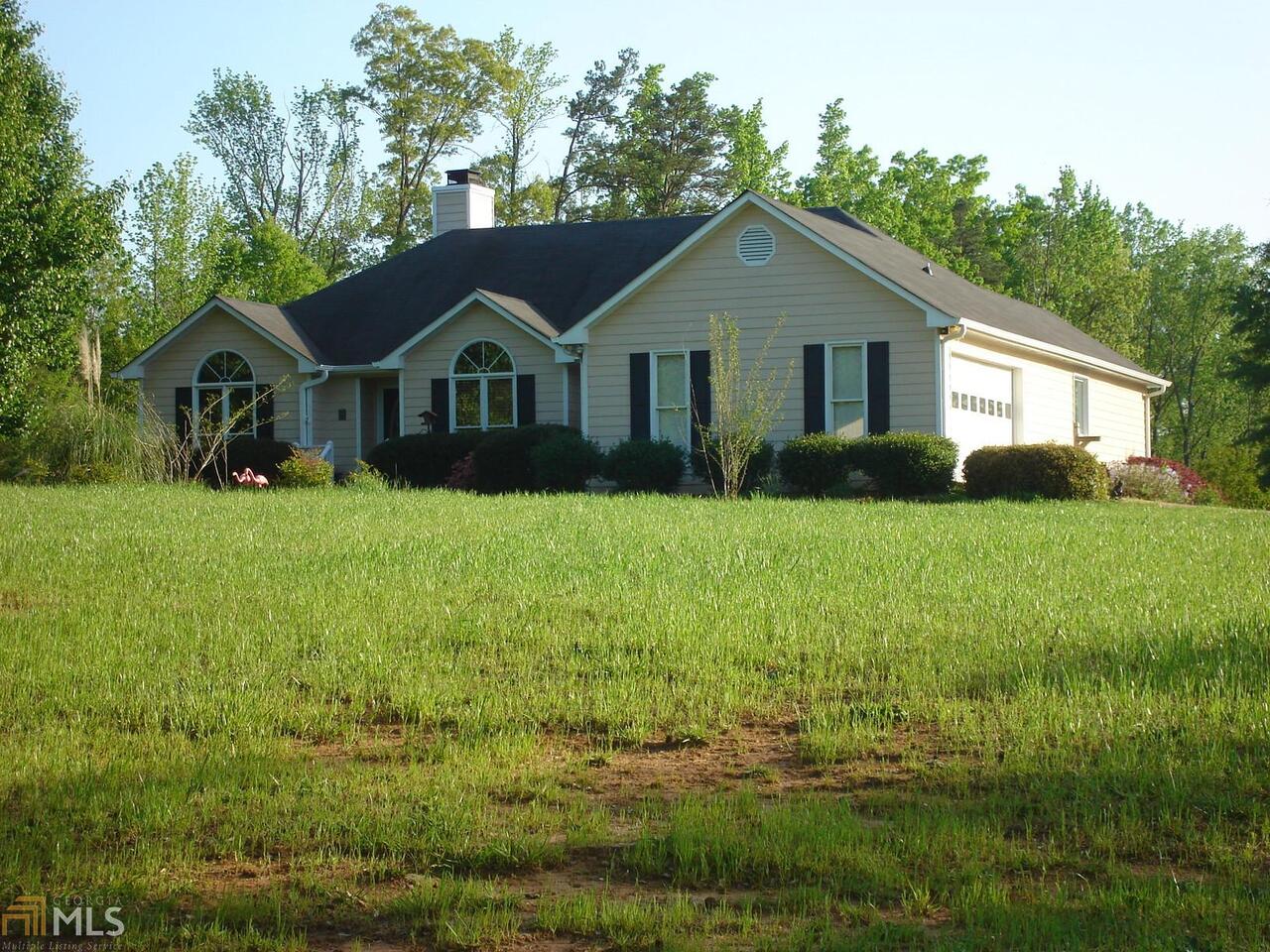 163 Adams Road Jefferson, GA 30549 - Photo 1 of 1 a front view of a house with yard and green space