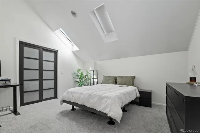 a bedroom with a bed a television and wooden floor