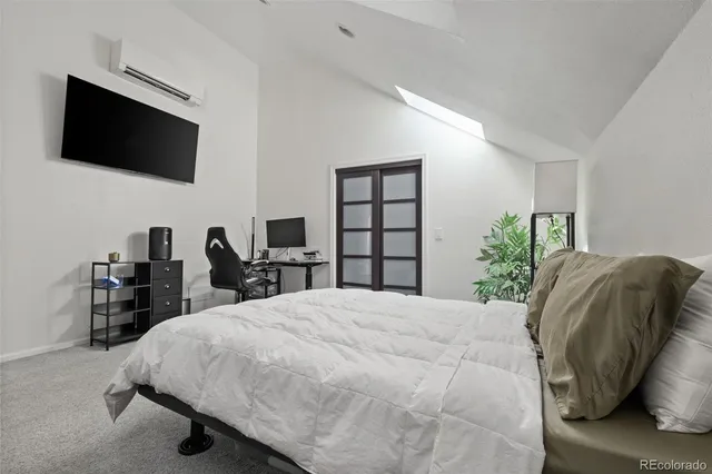 a large bed sitting in a bedroom next to a window