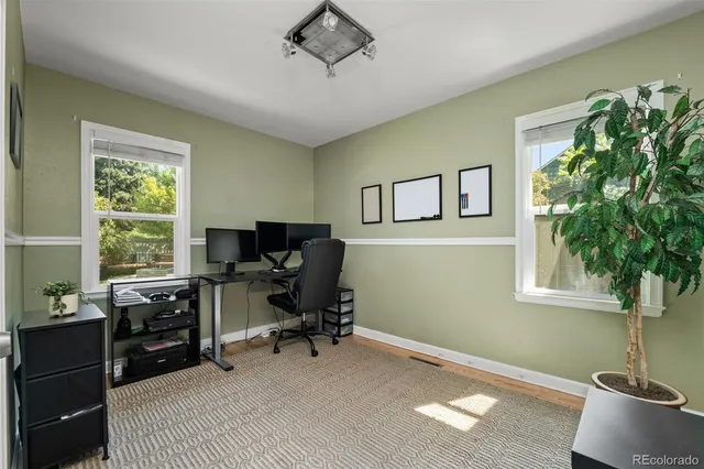 a view of workspace with furniture and windows