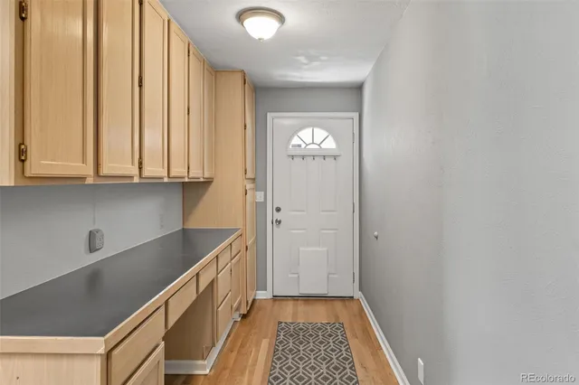 a dining room with a wooden table and chairs