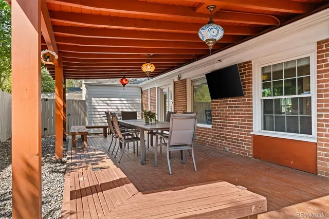 a view of a patio with table and chairs and wooden floor