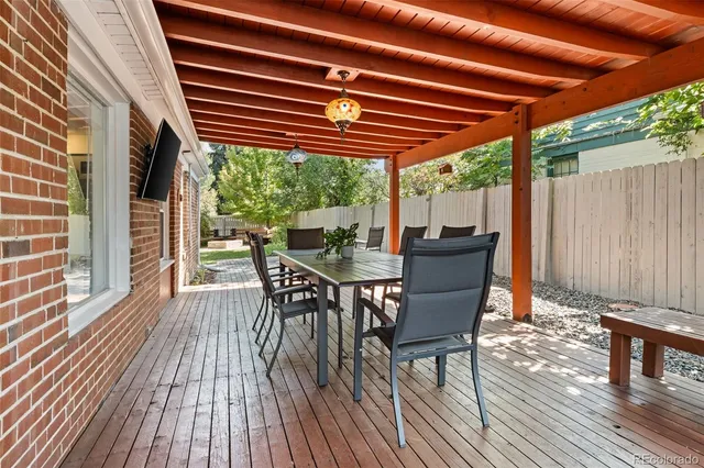 a outdoor dining space with furniture and wooden floor