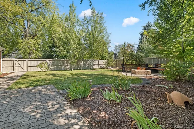 a backyard of a house with table and chairs