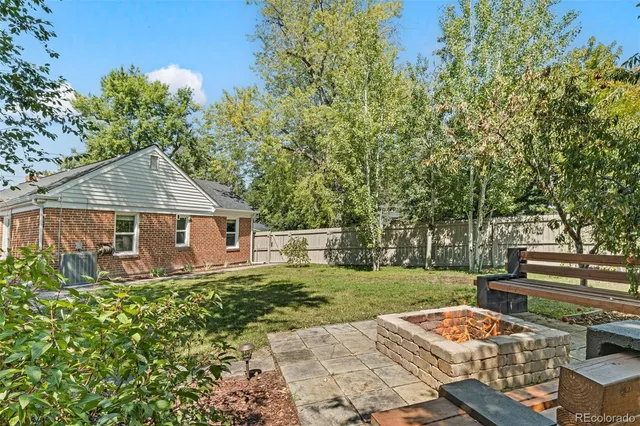 a view of a house with backyard and sitting area