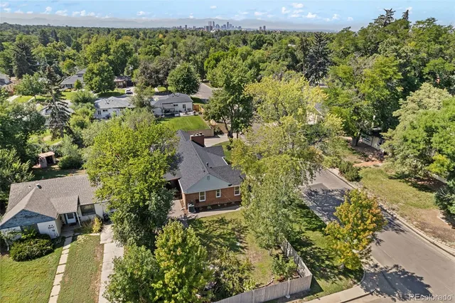 an aerial view of a house with a yard and garden