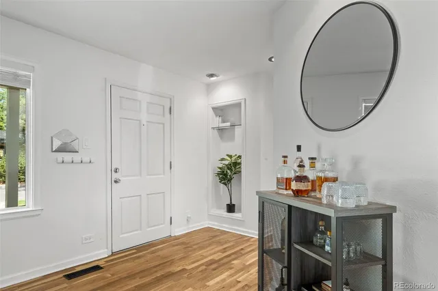 a view of a dining room with furniture and a large window
