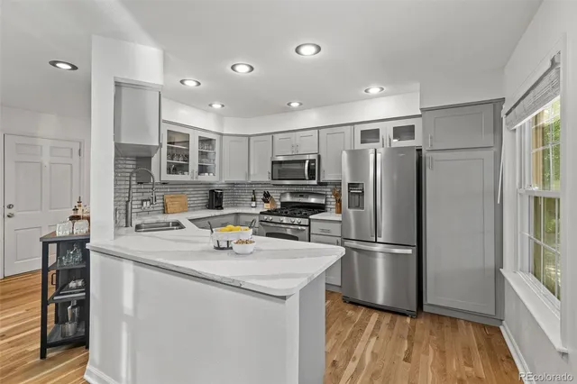 a kitchen with stainless steel appliances a refrigerator a stove and a sink