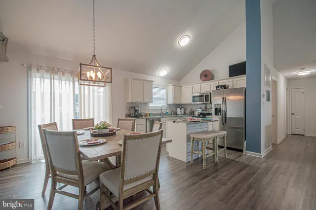 a view of a kitchen area with furniture and wooden floor