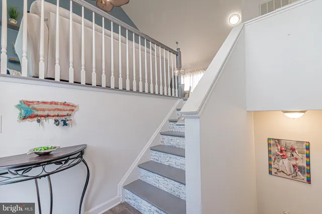 a dining room with stainless steel appliances kitchen island granite countertop a table chairs and a view of living room